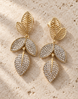 JORGINA - BOUCLES D'OREILLES DORÉES AVEC FEUILLES AVEC CRIXTAUX blanc