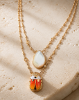 GAS BIJOUX - COLLIER SCAPULAIRE SERTI SCARABÉE DORÉ - EMAIL ORANGE ET BLANC ET NACRE BLANCE