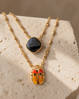 GAS BIJOUX - COLLIER SCAPULAIRE SERTI SCARABEE DORÉ -  ÉMAILLÉ ORANGE ET PIERRE ONYX