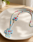 COLLECTION TOPAZE - SAUTOIR " CROIX FE" BLEU CIEL MULTICOLORE