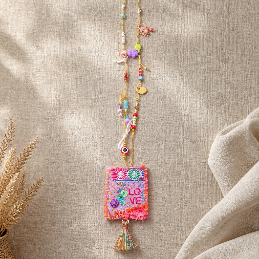 COLLECTION TOPAZE - SAUTOIR "LOVE" ROSE FUCHSIA A POMPON
