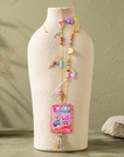 COLLECTION TOPAZE - SAUTOIR "LOVE" ROSE FUCHSIA A POMPON