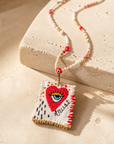COLLECTION TOPAZE - SAUTOIR "TRUST" COEUR OEIL BLANC ET ROUGE